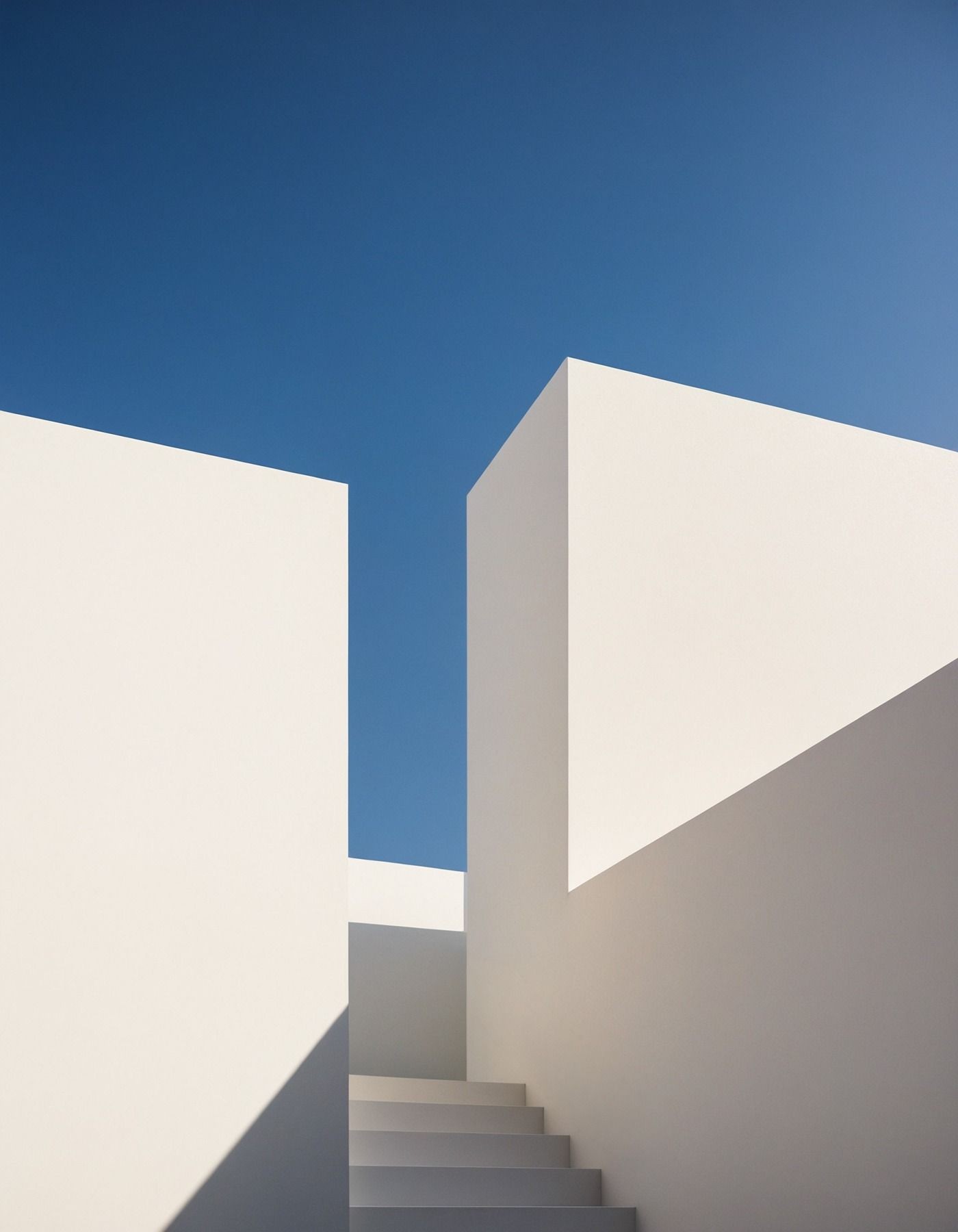 Sunlit white walls against a deep blue sky